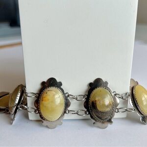 Silver tone stone bracelet with fold over clasp